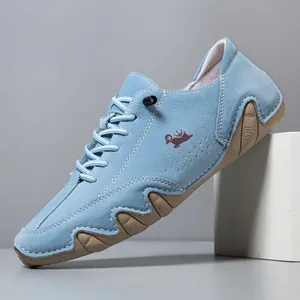 Light blue suede casual men's shoe with purple logo and wavy gum sole detail