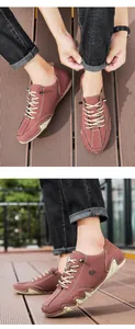 Detail of brick red low-top casual shoes with goat logo and cream stitched rubber soles