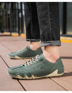 Detail of dark green suede casual shoes featuring cream contrast stitching and octopus sole