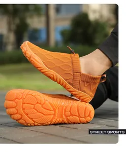 Detail of orange barefoot shoe with anti-slip rubber sole and adjustable drawstring system