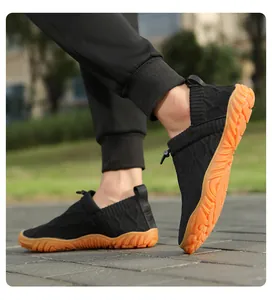 Close-up of flexible knit material and anti-slip rubber sole on camel trekking shoes