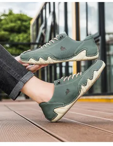 Macro shot of gray-green nubuck casual shoe showing textured waves and sheep logo