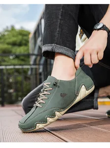 Detail of dark green leather low-top casual men's shoe with side stitching and rubber sole