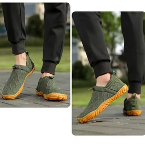 Detail view of dark green knit barefoot shoes with non-slip rubber soles and drawstring