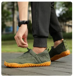 Detail of green barefoot shoe with breathable knit fabric and non-slip rubber sole