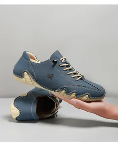 Detail of blue suede leather casual shoes showing contrast stitching and thick rubber sole