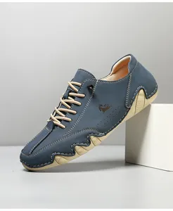 Detail of navy blue suede casual shoe featuring contrast stitching and wavy outsole