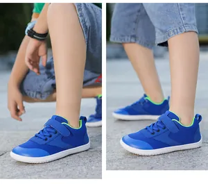 Close-up of kids barefoot shoes with blue breathable mesh and green velcro strap closure