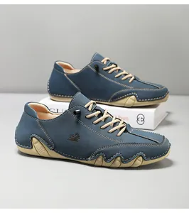 Macro view of blue nubuck leather shoes showing anti-slip wavy rubber outsole and logo