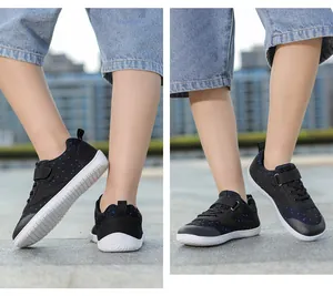 Detail of kids barefoot sneakers with breathable black mesh upper and anti-slip rubber sole