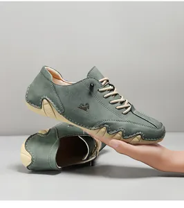 Detail of grey-green suede leisure shoes featuring octopus-style rubber sole and logo