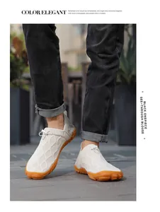 Close-up of white breathable knit outdoor water shoes with orange non-slip rubber sole