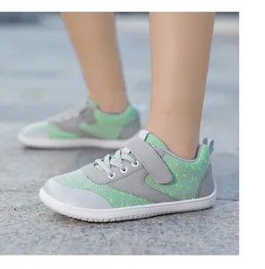 Detail view of breathable grey and green kids barefoot sneakers with hook and loop closure