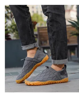 Detail of dark grey barefoot water shoe with non-slip gum rubber sole and drawstring closure