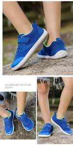 Detail view of breathable navy blue mesh barefoot kids' sneakers with Velcro straps