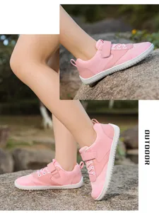 Detail of pink breathable mesh kids barefoot shoe with velcro strap and non-slip white sole
