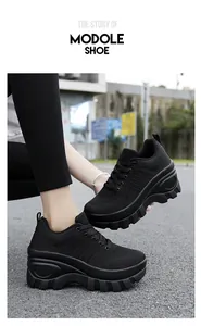 Detail of black platform sneakers with breathable mesh and side heart embossed pattern