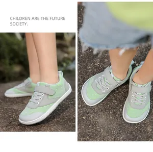 Detailed close-up of grey and green breathable wide-toe mesh sneakers with velcro strap