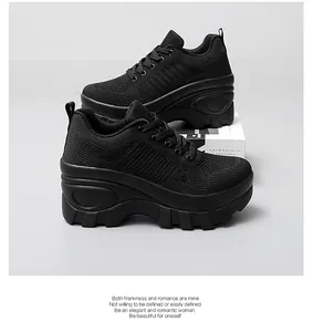 Detail view of the breathable black mesh upper and chunky platform sole on sports shoes