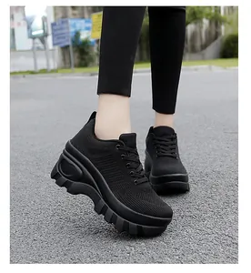 Detail view of black breathable knitted upper and chunky wave sole on platform sneakers