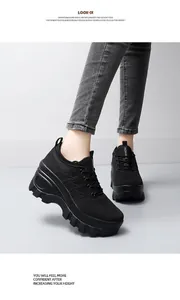 Detail of black breathable mesh platform sneakers worn with grey jeans in casual style