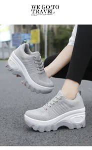 Detail view of grey thick-soled mesh sneakers with heart-shaped relief and rubber tread
