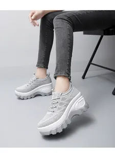 Detail of light gray mesh walking shoe featuring a platform sole with a side heart motif