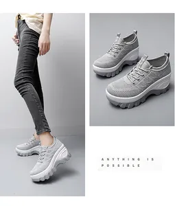 Detail of light grey mesh walking shoe featuring thick platform sole and side heart accent