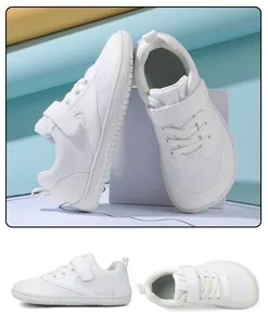 Detail of white kids wide-toe barefoot shoes with breathable mesh and velcro straps