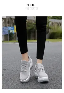 Close-up of grey breathable mesh chunky sneakers with thick anti-slip platform soles