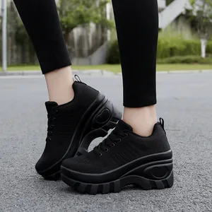 Women's black breathable mesh platform sneakers with heart-shaped sole detail and laces