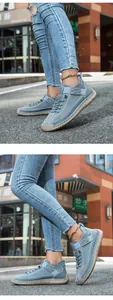 Macro detail of hand-stitched grey canvas casual shoes with durable beige rubber flat soles
