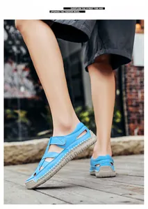 Macro detail of sky blue casual sandals with woven cut-out design and stitching on soft sole