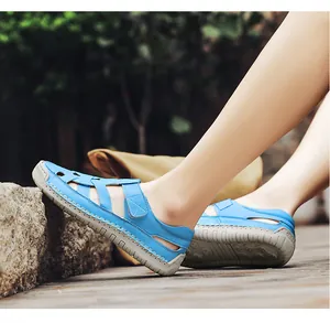 Detail of blue leather summer sandals with hand-stitched seams and breathable cutouts