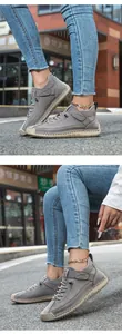 Detail of dark grey walking shoes featuring hand-stitched seams and non-slip rubber soles