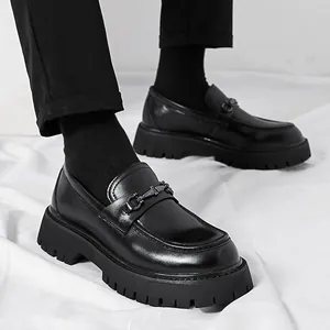 Men's black patent leather platform loafers with chunky lug sole and metal horsebit detail
