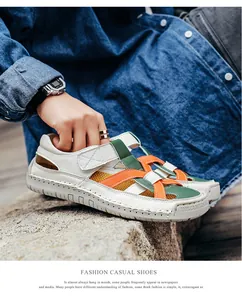 Detail of hand-stitched leather sandals with colorful straps and rubber sole marking