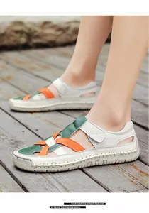 Detail of woven straps and velcro closure on beige sandals with rubber sole