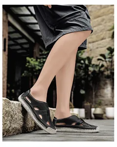 Outdoor lifestyle shot of black leather cut-out sandals with comfortable beige soles