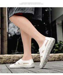 Detail of white woven slip-on sandals featuring breathable cut-outs and soft thick soles