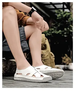 Macro view of white woven leather sandals with reinforced stitching and rubber sole