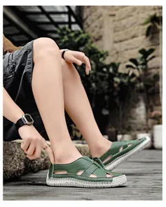 Detail of dark green leather sandals featuring hollow breathable structure and rubber soles