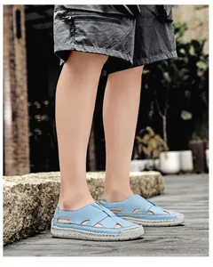 Close-up of light blue woven leather sandals with breathable hollow out design and rubber sole
