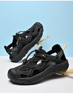Detail of men's outdoor sandals showing black closed-toe design and white stitching accents
