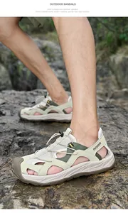 Outdoor male hiking sandals with closed toe design and breathable cut-outs on rocky terrain