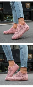 Close-up of pink breathable mesh sneakers with suede details and a horse logo for women