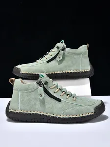 Detail of mint green suede casual boot featuring side zipper and sturdy hand-stitched sole