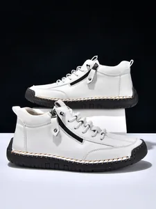 Close-up of men white high-top leather boots with side zippers and thick black rubber soles