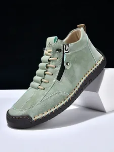 Detail shot of men's casual boot featuring green matte leather and side zipper closure
