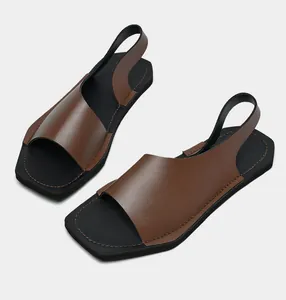 Dettaglio di sandali in pelle marrone scuro con cuciture fini e suola in gomma nera